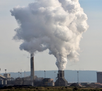 Industrial chimneys billowing smoke