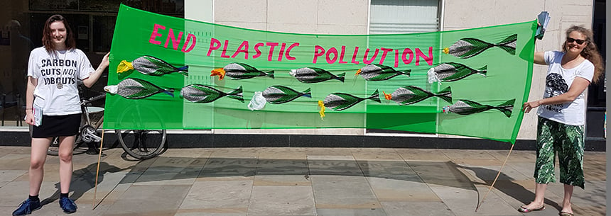 Activists with End Plastic Pollution Banner
